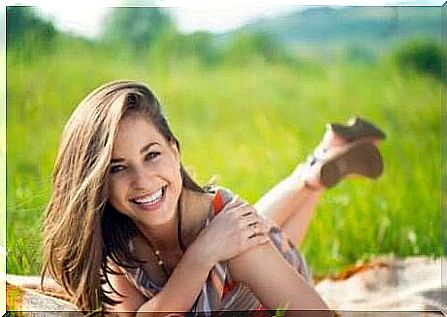 happy woman lying on a meadow