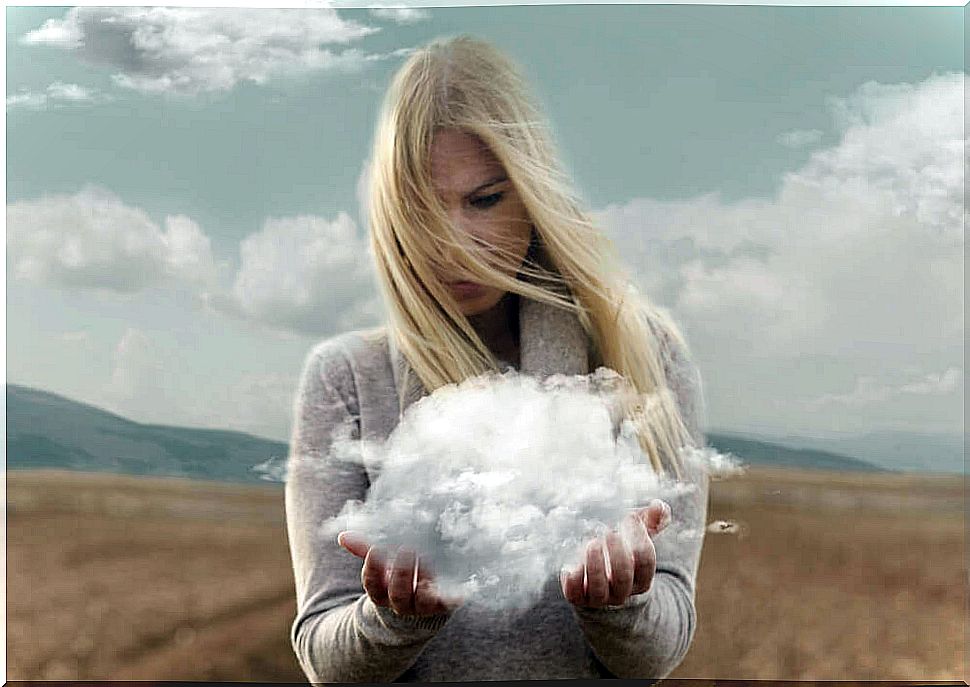 Woman looking at the cloud in her hands