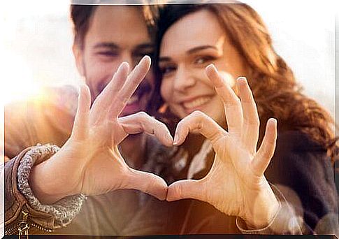 Couple making heart with their hands