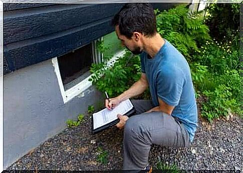 An inspector assessing a house.