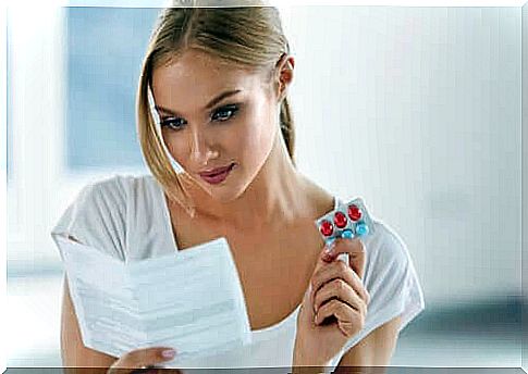 Woman reading the instructions for use on medicine