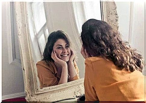 A teenager smiling in the mirror.