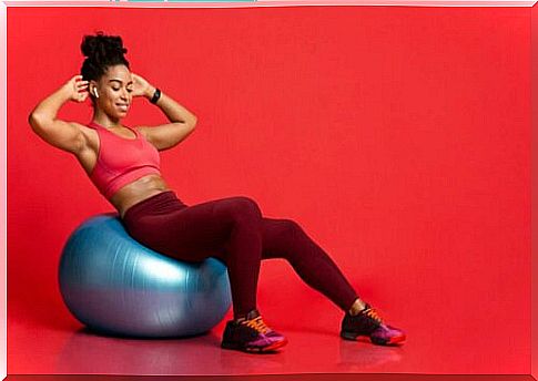 A woman trains against scoliosis on a ball