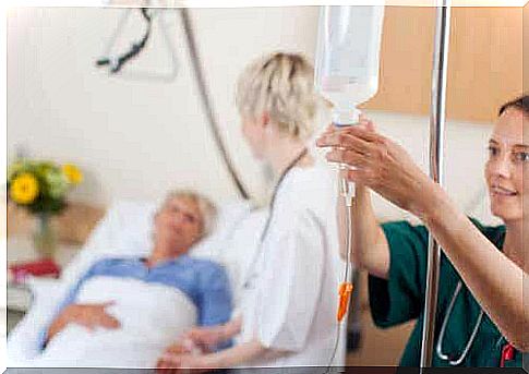 A woman setting up an intravenous drip.