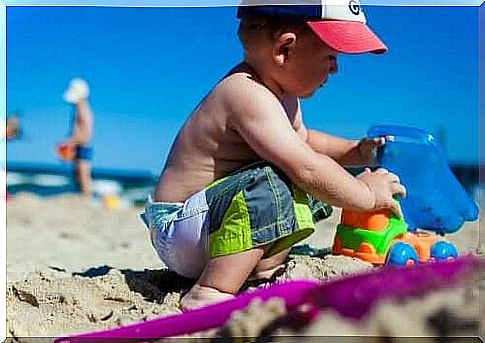 A child playing in the sand.