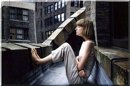 Woman sitting on roof terrace