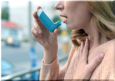 A woman using an inhaler