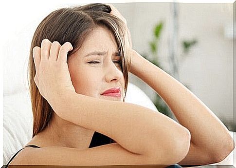 Young woman with stress headache in pain