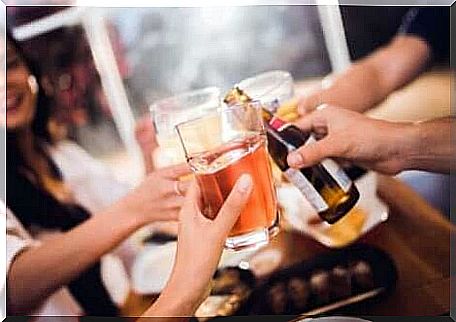 Friends toasting with alcohol at the bar.