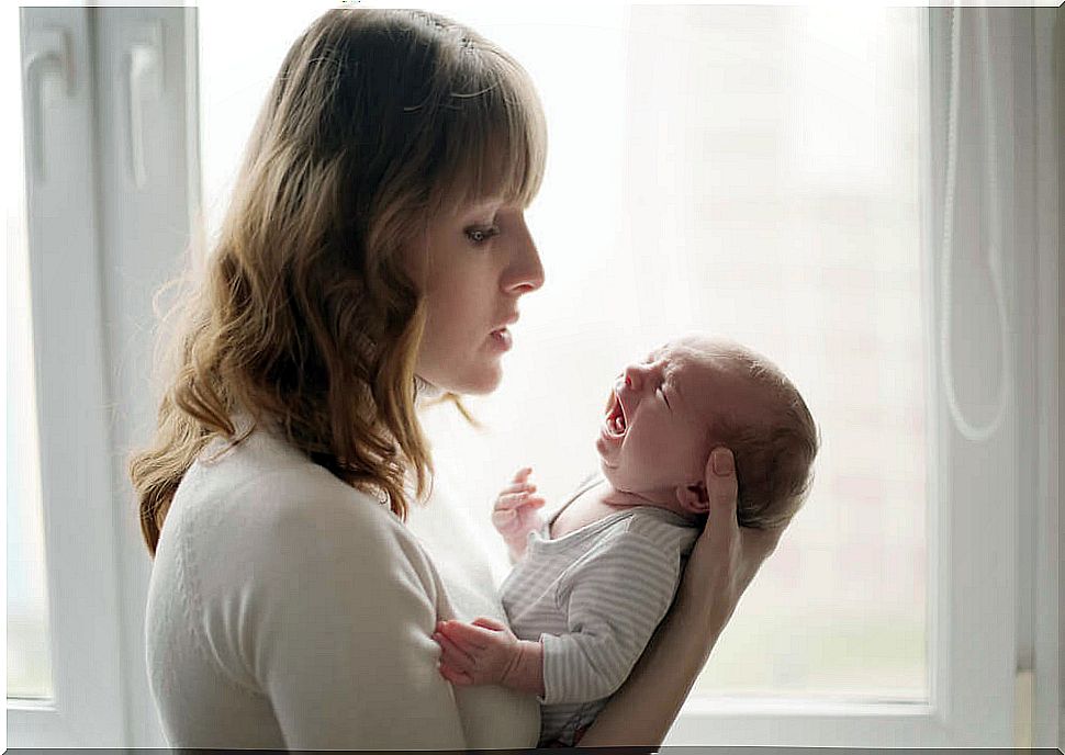 A mother with a crying baby.