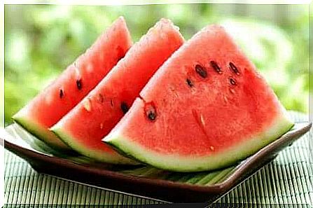 Watermelon slices standing on a table.